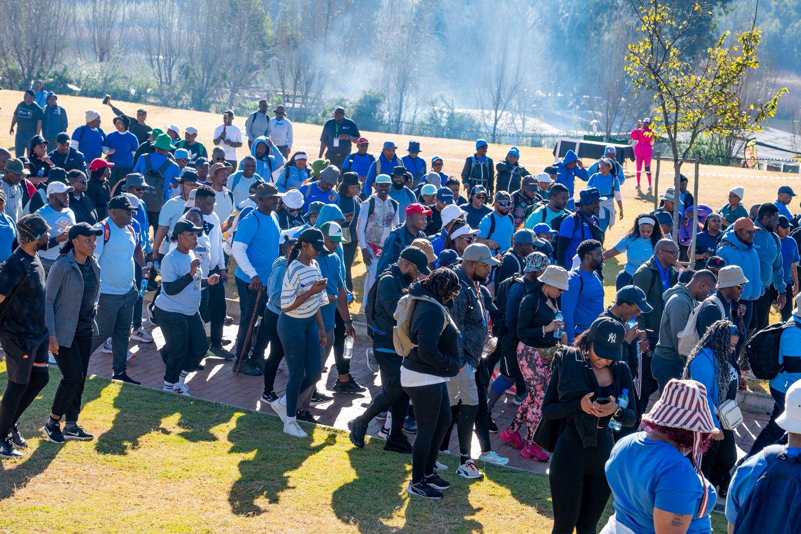 Hundreds of Couples Hiking Events members gathered together on a grass field